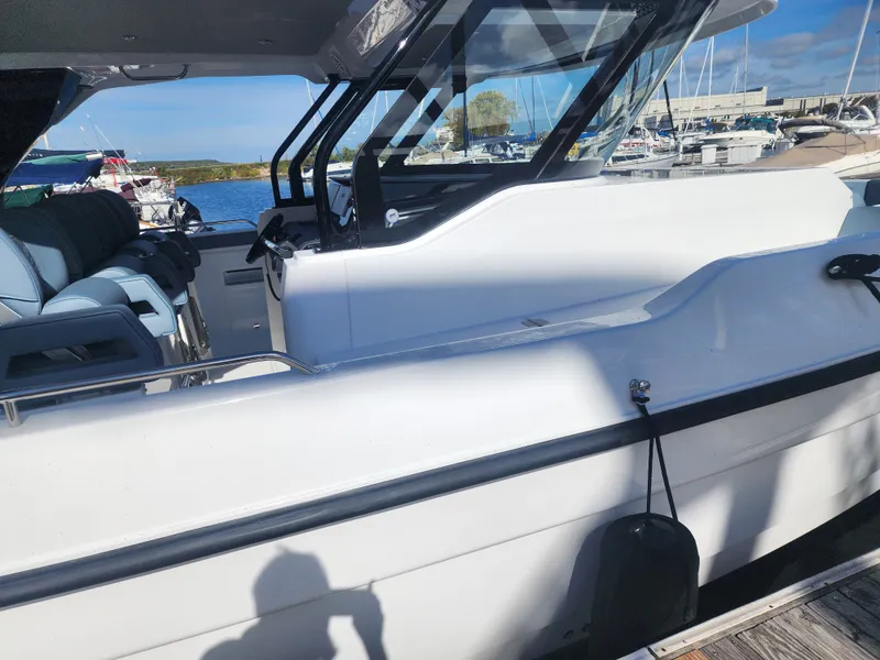Slide: The Image of The 2027 Cruisers Yachts 45VTR is docked. It features a sleek design with comfortable seating. - 5