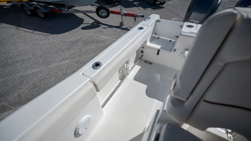 Slide: The Image of The image shows the cockpit of a 2020 Sea Hunt Gamefish 25 boat with white upholstery. - 26