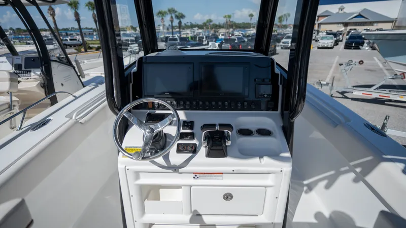 Slide: The Image of The image shows the cockpit of a 2020 Sea Hunt Gamefish 25 boat with modern electronics. - 17