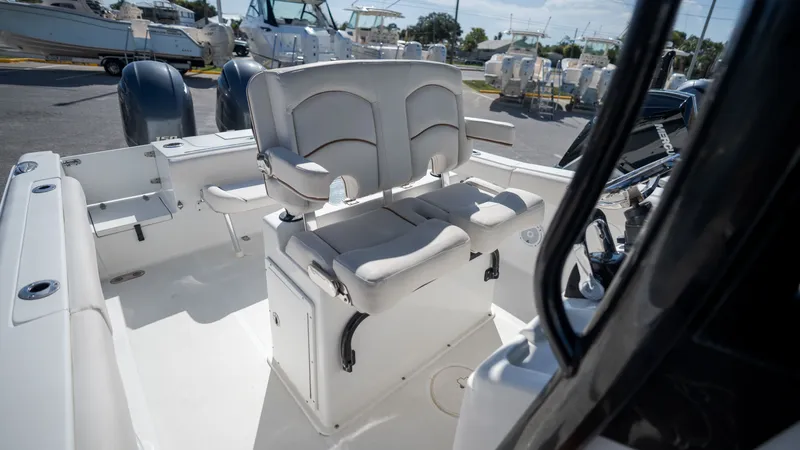 Slide: The Image of The image shows the cockpit of a 2020 Sea Hunt Gamefish 25 with two cushioned seats. - 24
