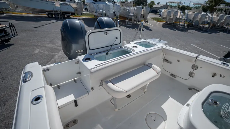 Slide: The Image of The image shows the cockpit of a 2020 Sea Hunt Gamefish 25 boat with dual engines. - 29