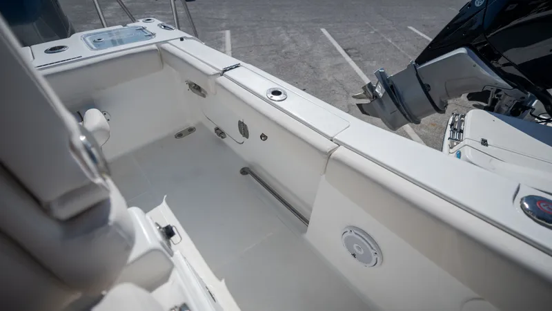 Slide: The Image of The image shows the cockpit of a 2020 Sea Hunt Gamefish 25 boat with a clean, white interior. - 27