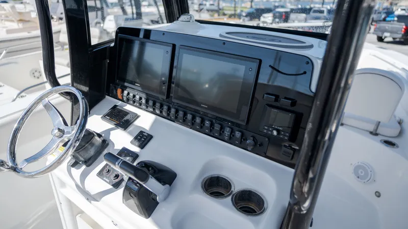 Slide: The Image of The image shows the helm of a 2020 Sea Hunt Gamefish 25 boat with modern instruments. - 18