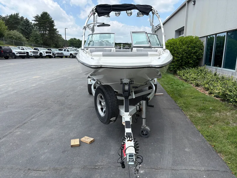 Slide: The Image of A 2011 MasterCraft X2 boat on a trailer in a parking lot. - 5