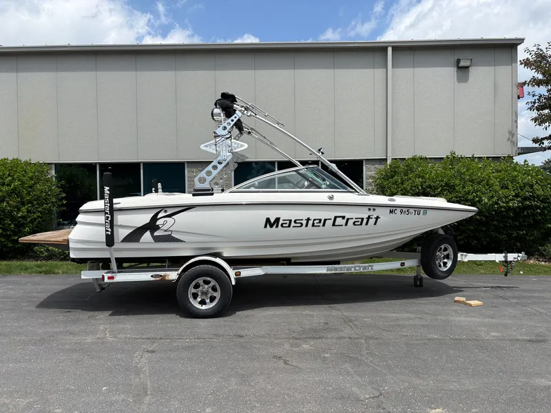 The Image of A 2011 MasterCraft X2 boat on a trailer in front of a building. - 1