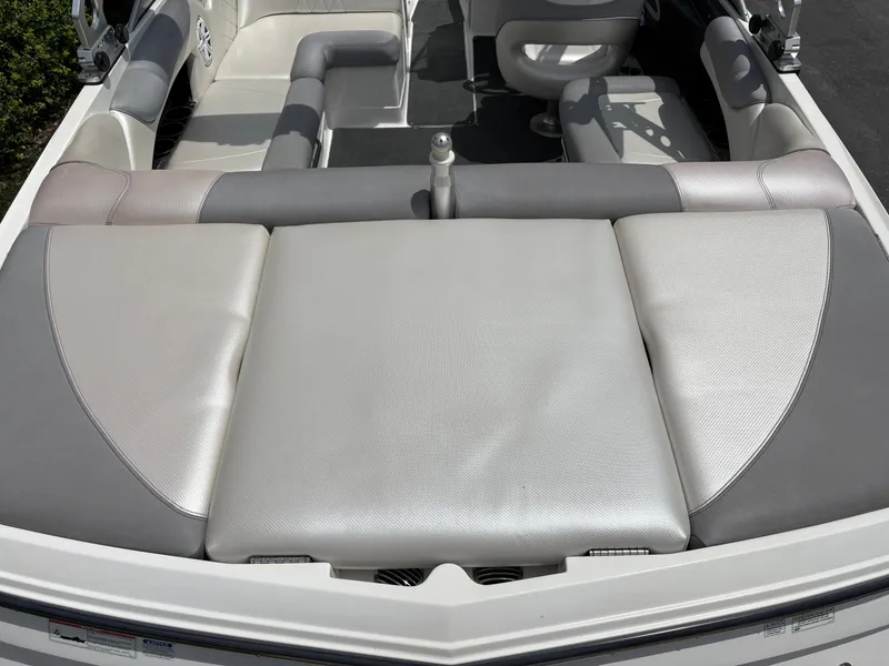 Slide: The Image of Rear view of a MasterCraft X2 boat with gray and white upholstery. - 10