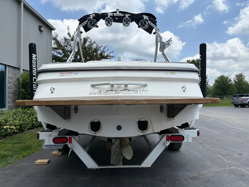 Slide: The Image of Rear view of a 2011 MasterCraft X2 boat on a trailer, ready for launch. - 8