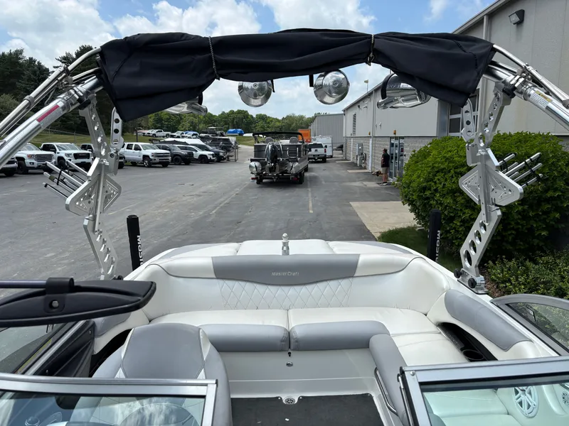 Slide: The Image of The image shows the cockpit of a 2011 MasterCraft X2 boat with white seating. - 24