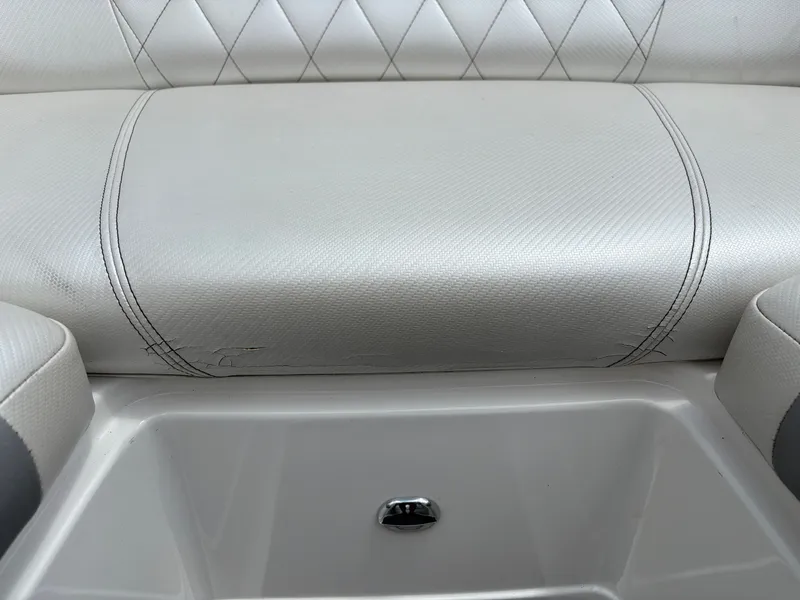 Slide: The Image of Close-up of a white seat with quilted pattern and a storage compartment below. - 23