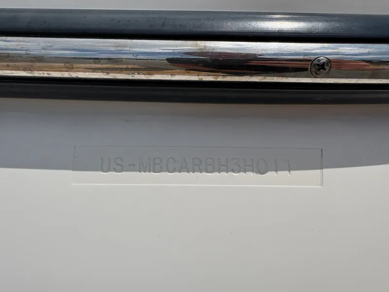 Slide: The Image of Close-up of a hull identification number on a boat with a metal rail. - 26