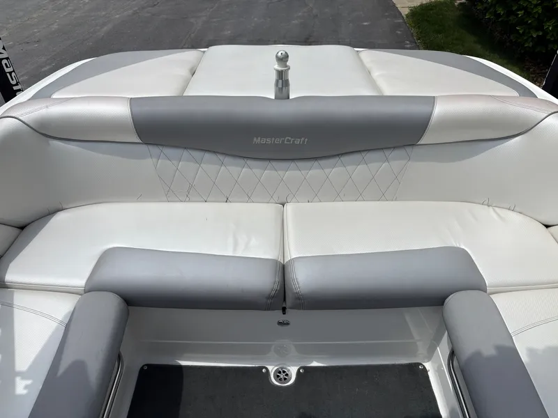 Slide: The Image of The image shows the stern of a MasterCraft X2 boat with gray and white upholstery. - 17