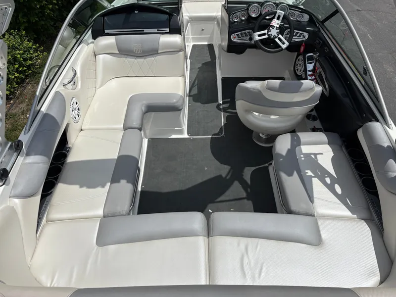Slide: The Image of Interior of a 2011 MasterCraft X2 with white and gray seating and a modern helm. - 12