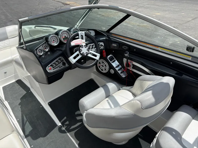 Slide: The Image of The image shows the cockpit of a 2011 MasterCraft X2 boat with modern instruments. - 13