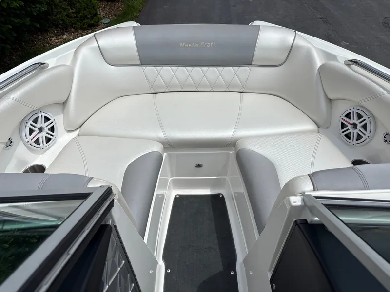 Slide: The Image of The image shows the bow area of a MasterCraft X2 boat with white and gray upholstery. - 22