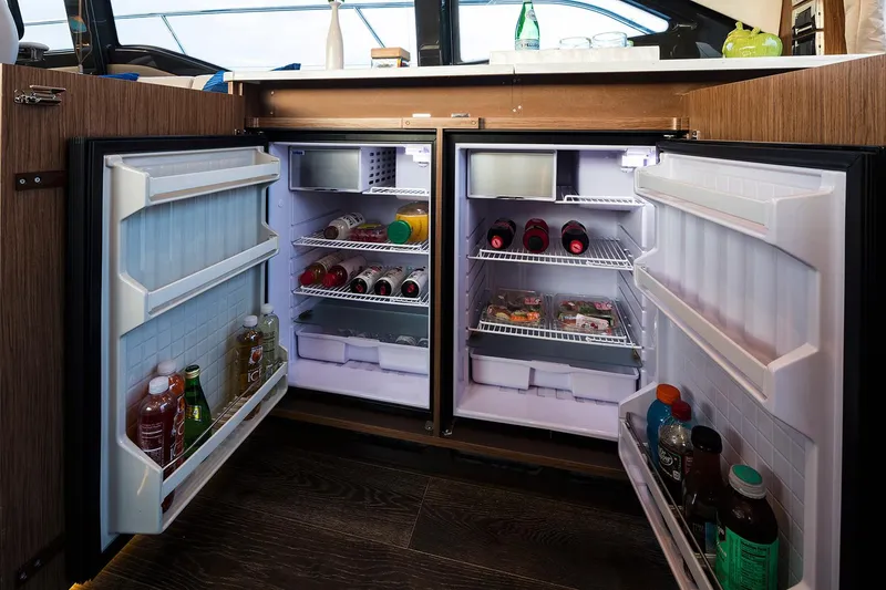 Slide: The Image of Manufacturer Provided Image: Open double-door refrigerator in 2018 Sea Ray Fly 460 yacht kitchen. - 10