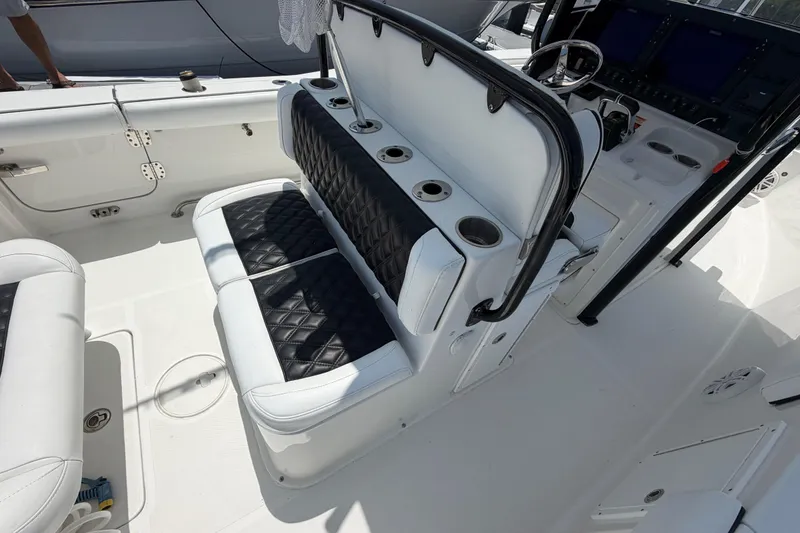Slide: The Image of 2019 Sea Hunt Gamefish 27 Coffin Box interior with cushioned seating and control panel. - 11