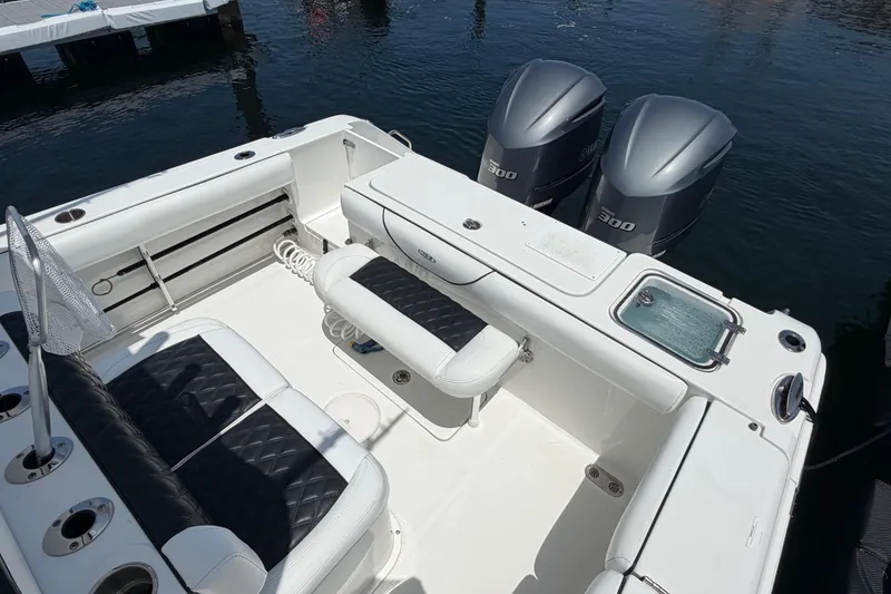 Slide: The Image of 2019 Sea Hunt Gamefish 27 Coffin Box boat interior with twin engines and seating. - 7