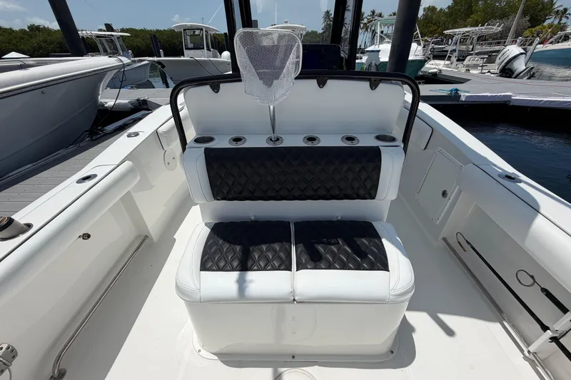 Slide: The Image of 2019 Sea Hunt Gamefish 27 Coffin Box boat interior with cushioned seating and rod holders. - 9