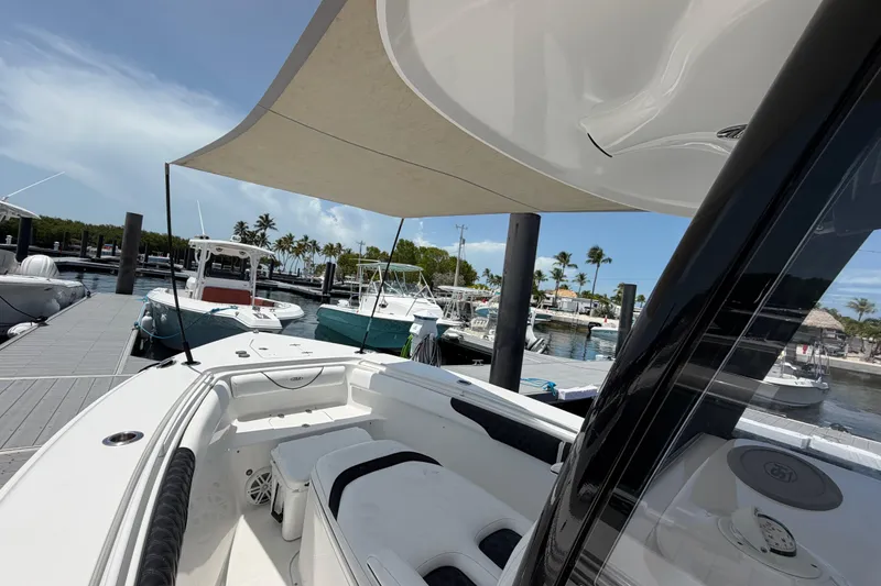Slide: The Image of 2019 Sea Hunt Gamefish 27 Coffin Box docked at marina under sunny skies. - 33