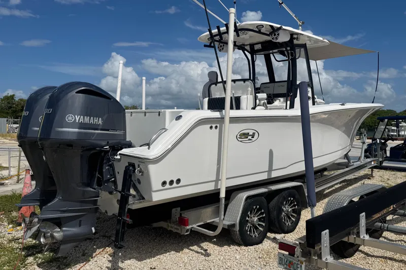 Slide: The Image of 2019 Sea Hunt Gamefish 27 Coffin Box boat with Yamaha engines on a trailer. - 39
