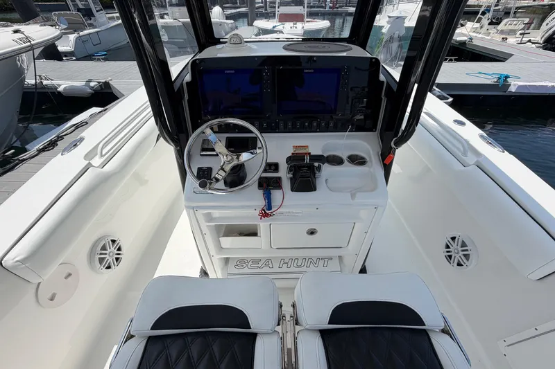 Slide: The Image of 2019 Sea Hunt Gamefish 27 Coffin Box boat cockpit with steering wheel and controls. - 12