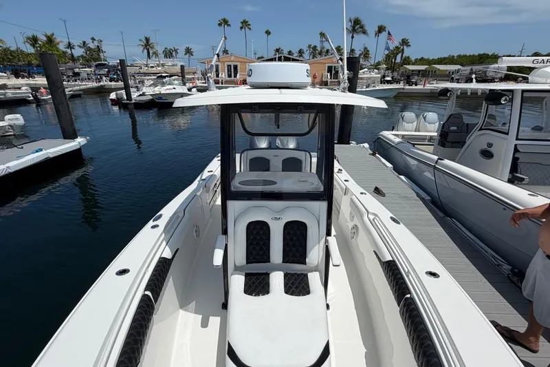Slide: The Image of 2019 Sea Hunt Gamefish 27 Coffin Box boat docked at marina with palm trees. - 19