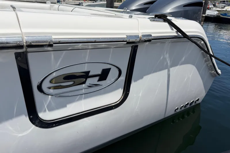 Slide: The Image of 2019 Sea Hunt Gamefish 27 Coffin Box boat docked, featuring SH logo and sleek design. - 37