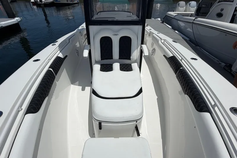 Slide: The Image of 2019 Sea Hunt Gamefish 27 Coffin Box boat interior with cushioned seating and sleek design. - 18