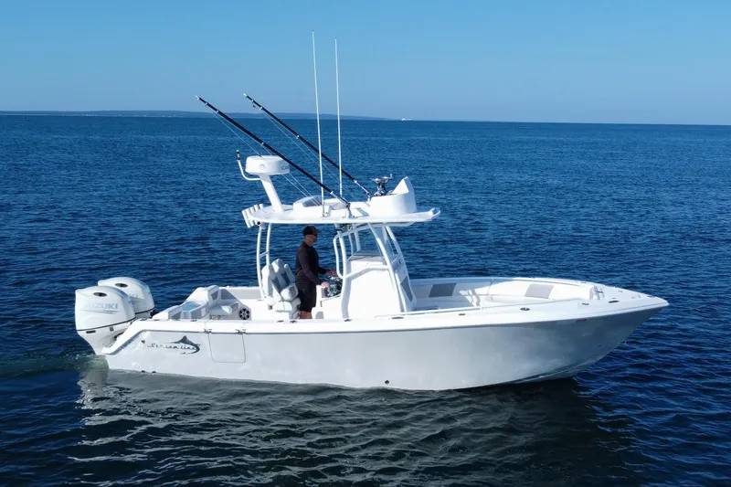 Slide: The Image of 2019 Streamline 26 TE boat on open water, featuring dual Suzuki engines. - 4