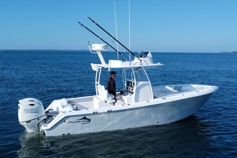 Slide: The Image of 2019 Streamline 26 TE boat on calm blue ocean with fishing rods and Suzuki engine. - 48