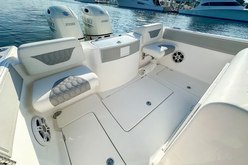 Slide: The Image of 2019 Streamline 26 TE boat interior with seating and dual Suzuki 200 engines. - 32