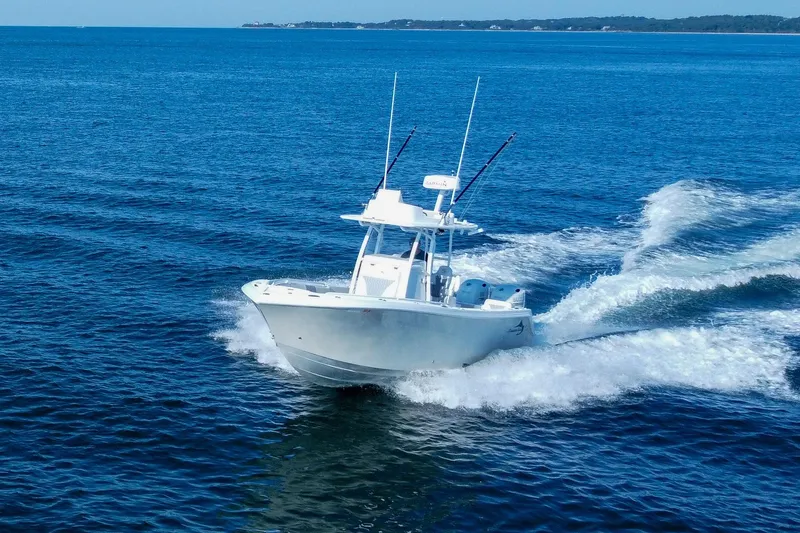 Slide: The Image of 2019 Streamline 26 TE boat cruising on open blue ocean waters. - 2