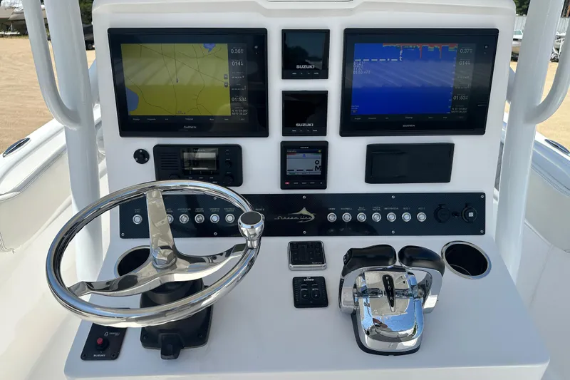 Slide: The Image of 2019 Streamline 26 TE boat dashboard with dual Garmin displays and steering wheel. - 3