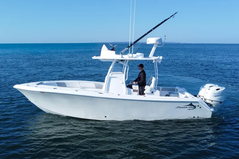 Slide: The Image of 2019 Streamline 26 TE boat on open water, featuring sleek design and Suzuki outboard engine. - 10
