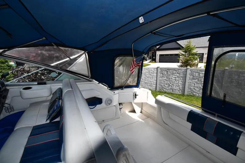 Slide: The Image of Interior of a 1993 Sea Ray 300 Sundancer boat with blue canopy and seating. - 15