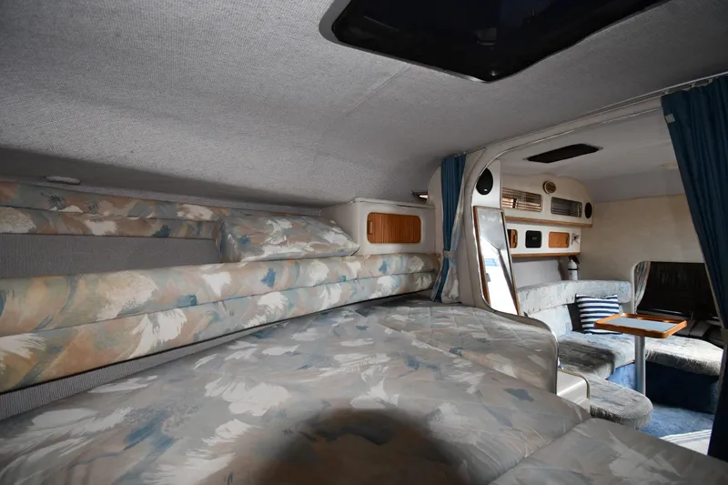Slide: The Image of Interior of 1993 Sea Ray 300 Sundancer with cozy sleeping and seating areas. - 23