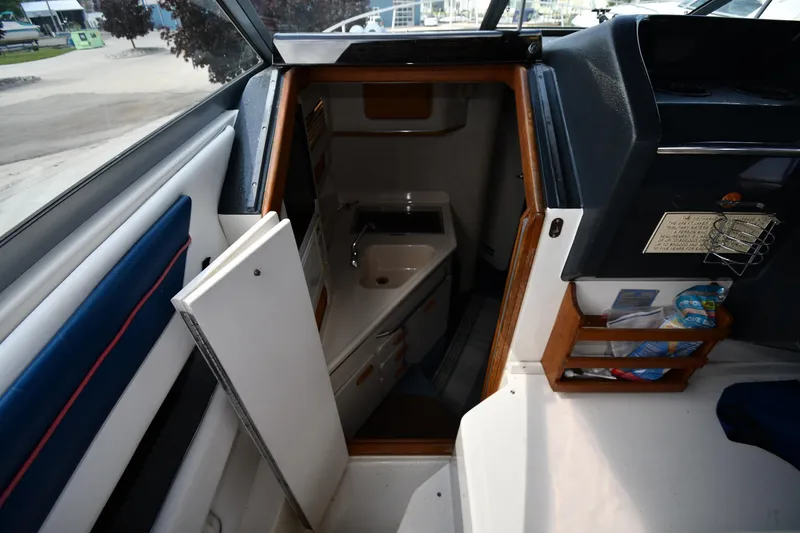 Slide: The Image of Interior view of a 1993 Sea Ray 300 Sundancer cabin with sink and storage. - 18