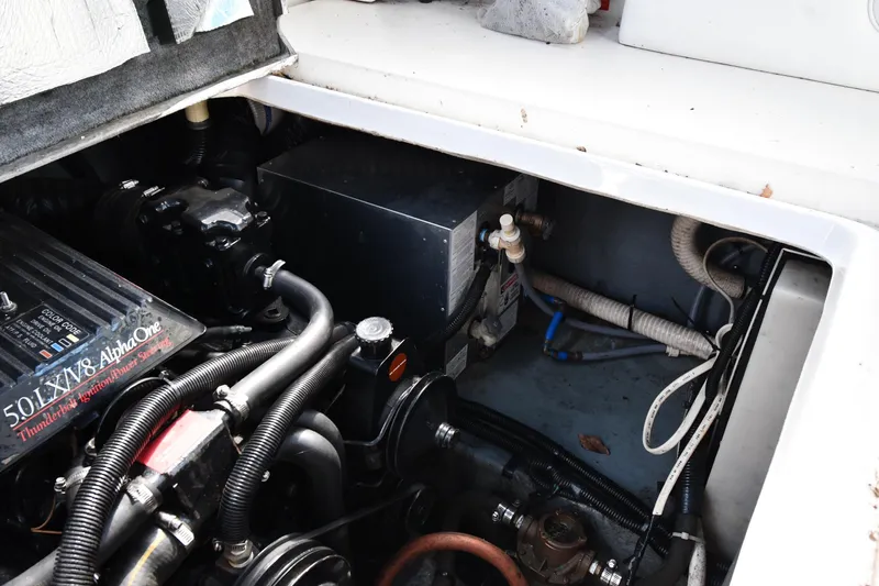 Slide: The Image of Engine compartment of a 1993 Sea Ray 300 Sundancer boat, showcasing mechanical components. - 38