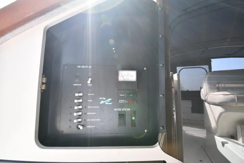 Slide: The Image of Electrical panel on a 1993 Sea Ray 300 Sundancer boat, showing various controls. - 34