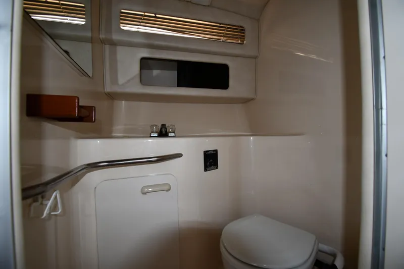 Slide: The Image of 1993 Sea Ray 300 Sundancer bathroom interior with toilet and sink. - 29