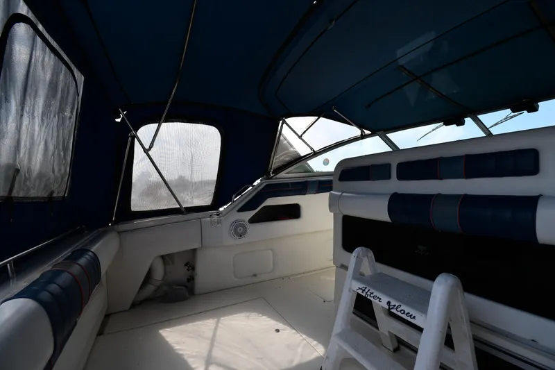 Slide: The Image of Interior view of a 1993 Sea Ray 300 Sundancer boat with blue and white seating. - 14