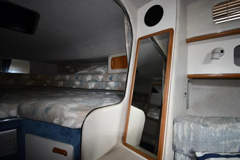Slide: The Image of Interior cabin of 1993 Sea Ray 300 Sundancer with bed, mirror, and storage shelves. - 20