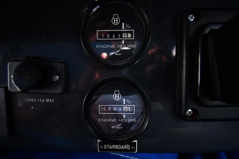 Slide: The Image of 1993 Sea Ray 300 Sundancer engine hour meters displaying 1067.1 and 1067.6 hours. - 17
