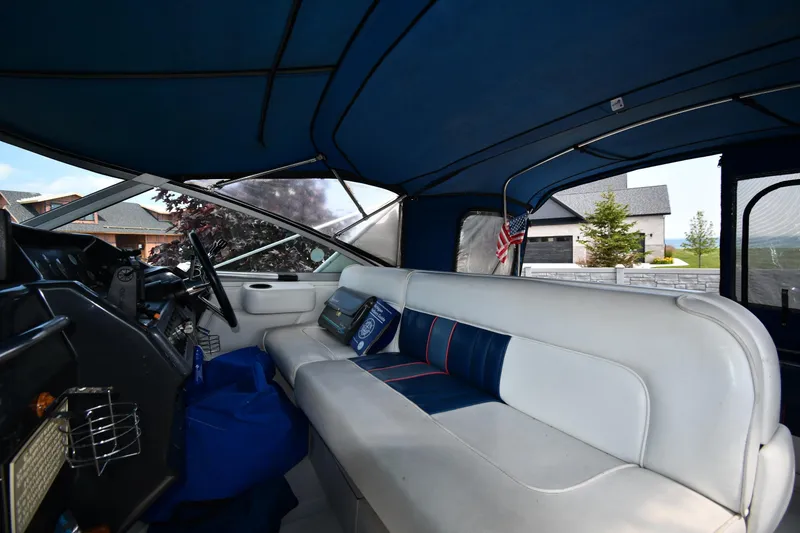 Slide: The Image of Interior of a 1993 Sea Ray 300 Sundancer boat with blue and white seating. - 12