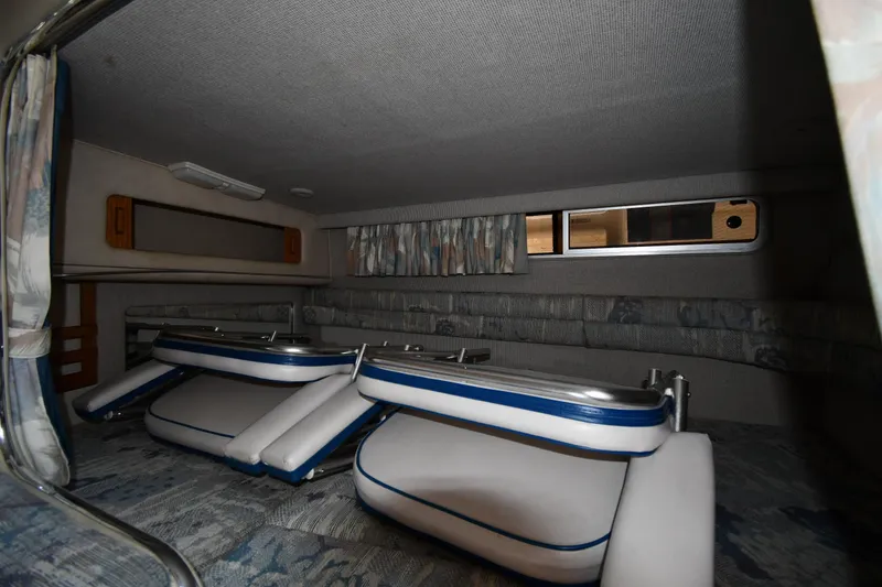 Slide: The Image of Interior cabin of 1993 Sea Ray 300 Sundancer with folded seating and window. - 30
