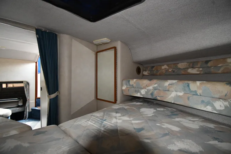 Slide: The Image of Interior cabin of 1993 Sea Ray 300 Sundancer with cozy sleeping area and patterned upholstery. - 22