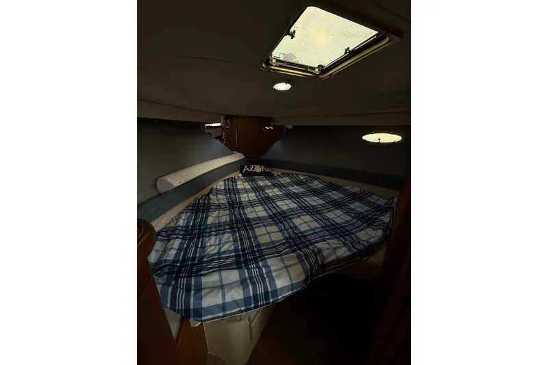 Slide: The Image of Cozy cabin interior of 1992 Carver 33 Aft Cabin Motor Yacht with plaid bedding. - 40