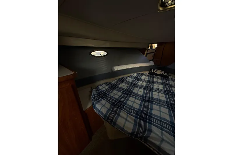 Slide: The Image of Cozy cabin interior of 1992 Carver 33 Aft Cabin Motor Yacht with plaid bedding. - 39