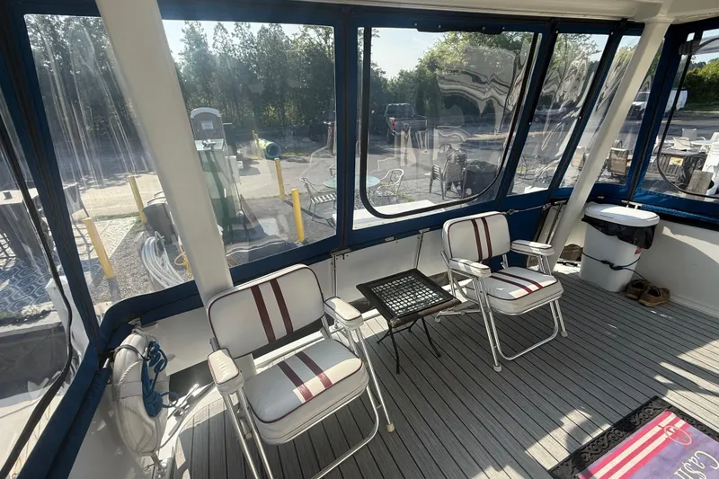 Slide: The Image of 1992 Carver 33 Aft Cabin Motor Yacht interior with chairs and table on deck. - 16