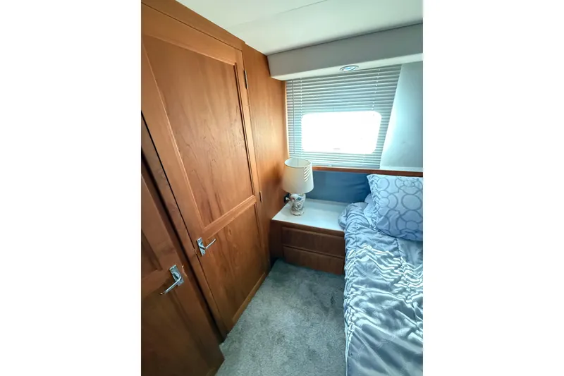 Slide: The Image of Cozy bedroom interior of 1992 Carver 33 Aft Cabin Motor Yacht with wooden cabinetry. - 43